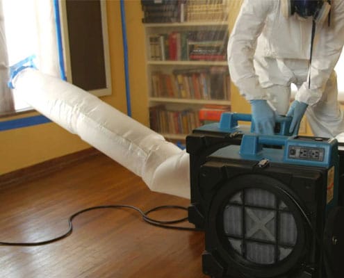 mold technician using negative air pressure equipment
